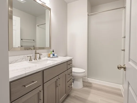 Unit turn bathroom renovation — updated vanity, quartz top, modern fixtures, Plano apartment community