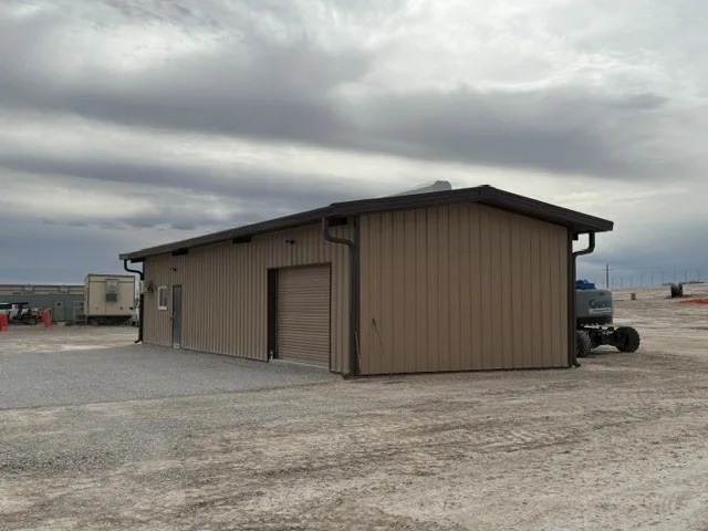 Tan metal operations facility on a graded pad at the Delaware Ranch Solar site in Culberson County, Texas, built by UTS BuildPros