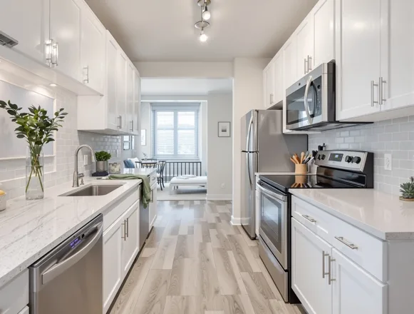 Completed unit turn — luxury vinyl plank flooring and quartz kitchen in Dallas apartment community