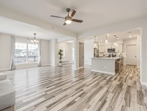 Completed living room unit turn — fresh paint, LVP flooring, modern lighting in Houston apartment